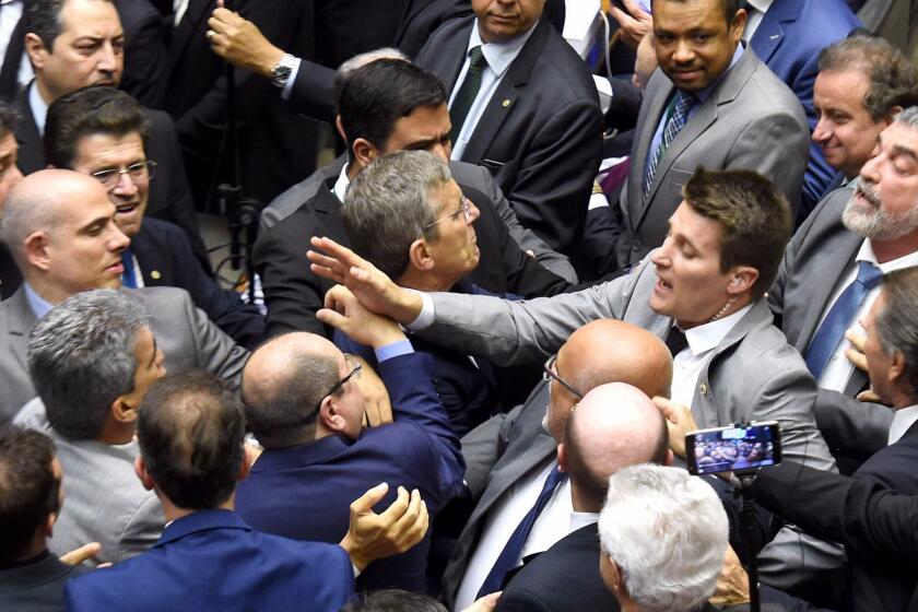 Deputies fight during a session at the Chamber of Deputies in Brasilia, Brazil, on August 2, 2017. Brazilian lawmakers angrily debated Wednesday ahead of an unprecedented vote on whether President Michel Temer should face trial for alleged corruption, just a year after his predecessor was booted from office. / AFP PHOTO / EVARISTO SAEVARISTO SA/AFP/Getty Images ** OUTS - ELSENT, FPG, CM - OUTS * NM, PH, VA if sourced by CT, LA or MoD **