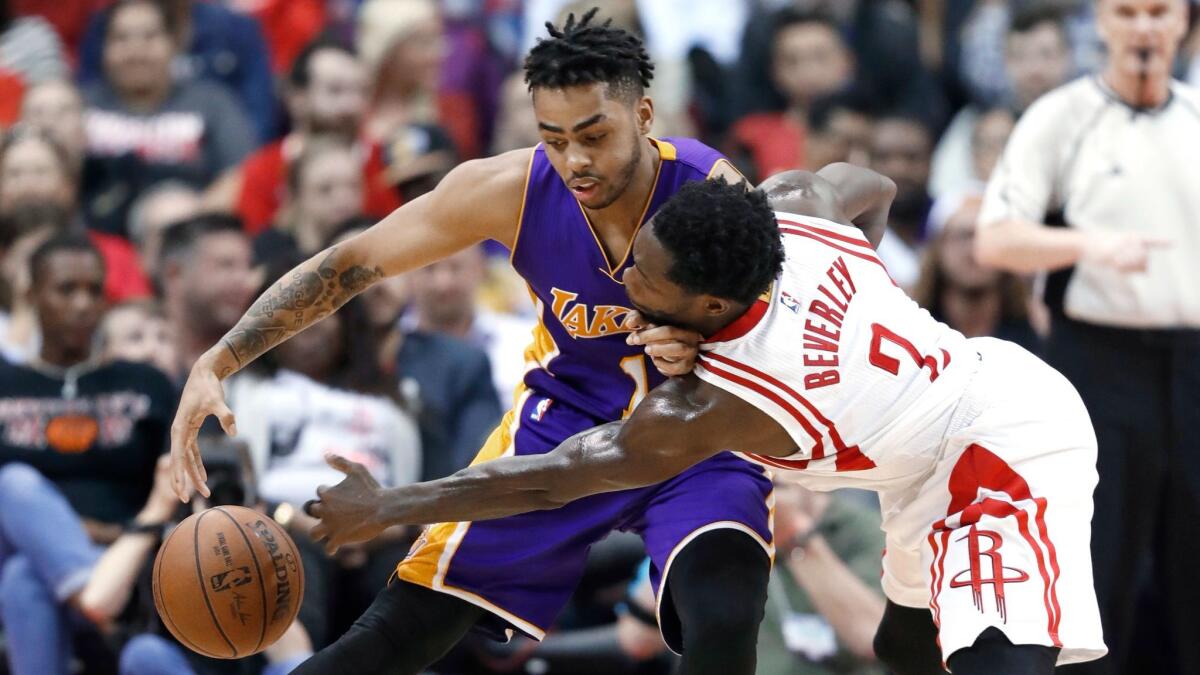 The Rockets' Patrick Beverley knocks the ball away from the Lakers' D'Angelo Russell during a March 15 game in Houston.