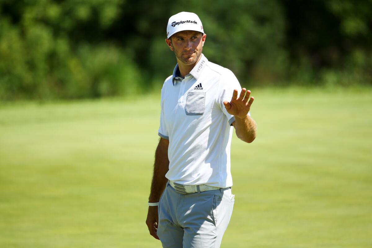 Dustin Johnson waves to the crowd on the ninth green of the 2015 PGA Championship at Whistling Straits.