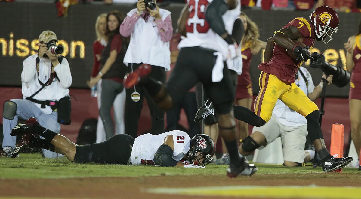 USC receiver Steven Mitchell leaves Arkansas State safety Cody Brown in the dirt as he scores the Trojans' second touchdown of the first half at the Coliseum.