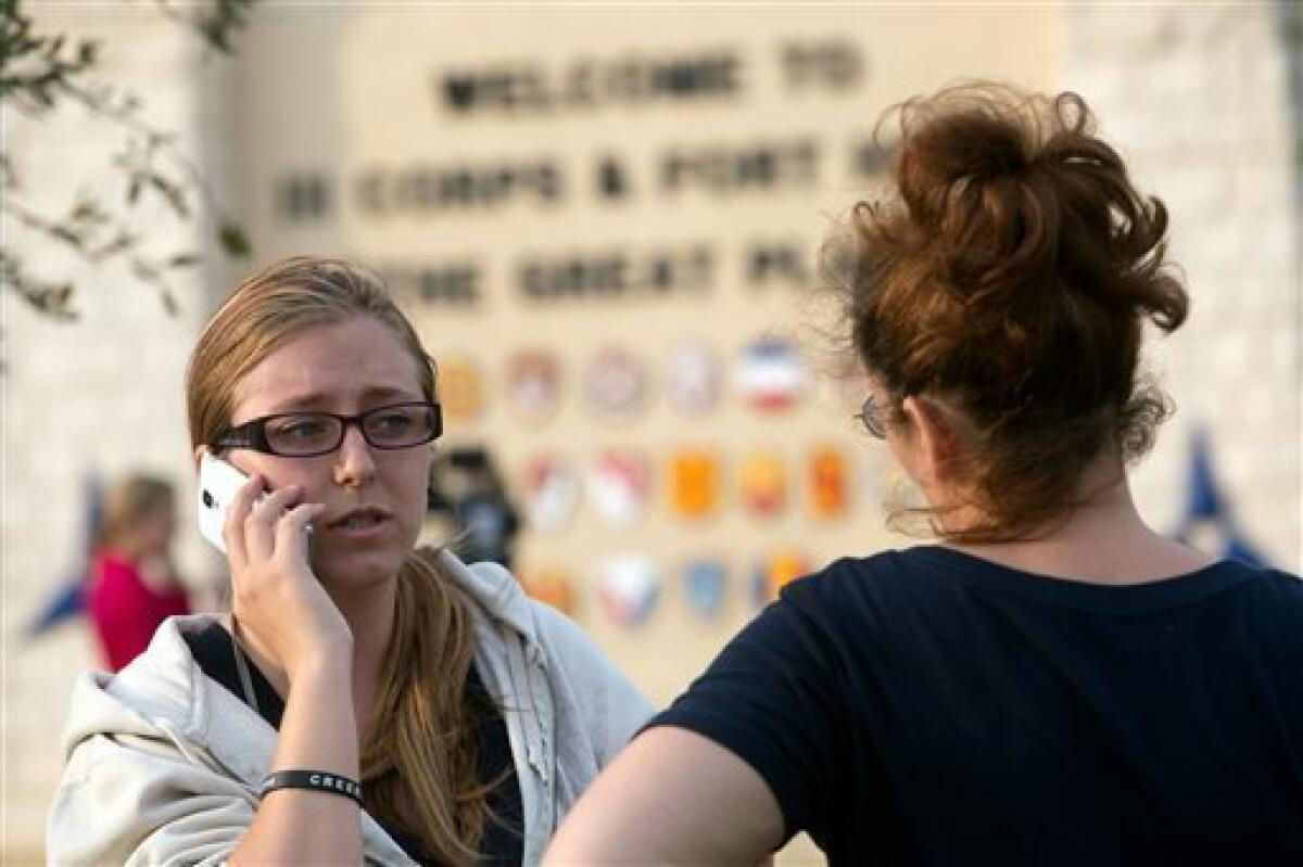 Krystina Cassidy, left, and Dianna Simpson try to contact their husbands after Ft. Hood was locked down because of the shooting.
