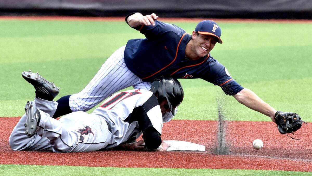 Cardinals baserunner Nick Solak collides with Cal State Fullerton's Timmy Richards during a pickoff attempt in the third inning of their NCAA super regional game on Sunday in Louisville, Ky.