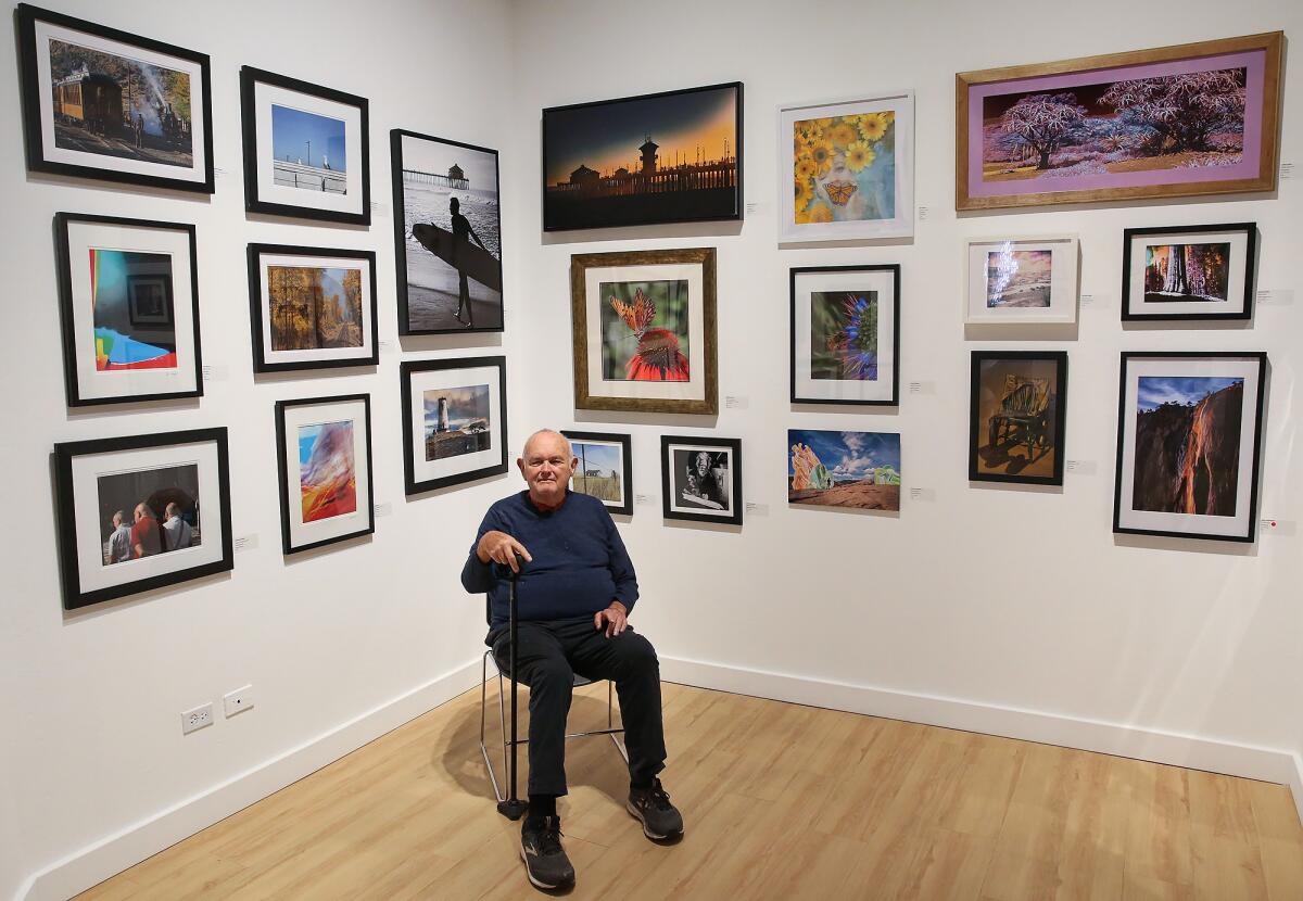 Fine art photographer Dan Meylor poses with some of the artwork in the "Centered on the Center" exhibition.