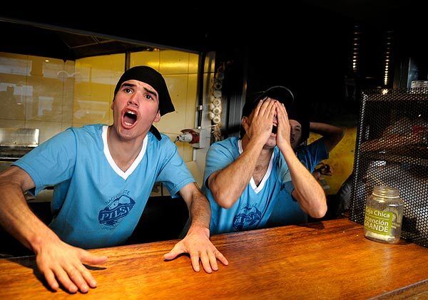 The kitchen staff at a restaurant in Montevideo, Uruguay, reacts while watching on TV the World Cup match between France and Uruguay on Friday.