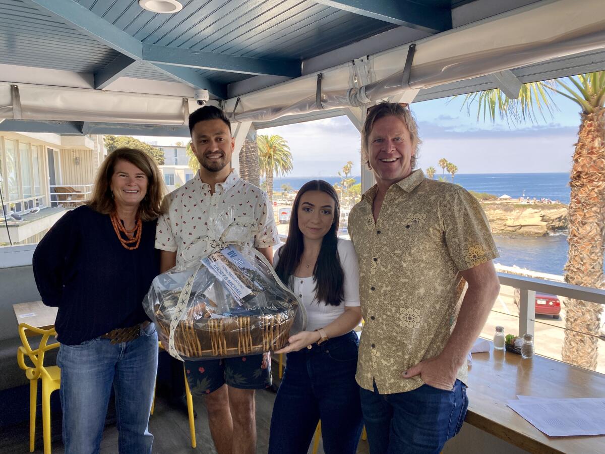 Megan (left) and Dave Heine (right), owners of Brockton Villa, congratulate Michael Sinha and Kelsey Halvorsen.