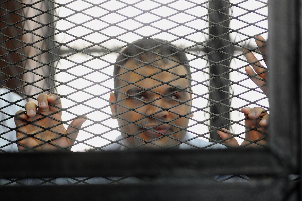 Al Jazeera journalist Mohamed Badr, shown in court in Cairo in December, was acquitted Sunday along with 61 others who were arrested in clashes with security forces last summer.