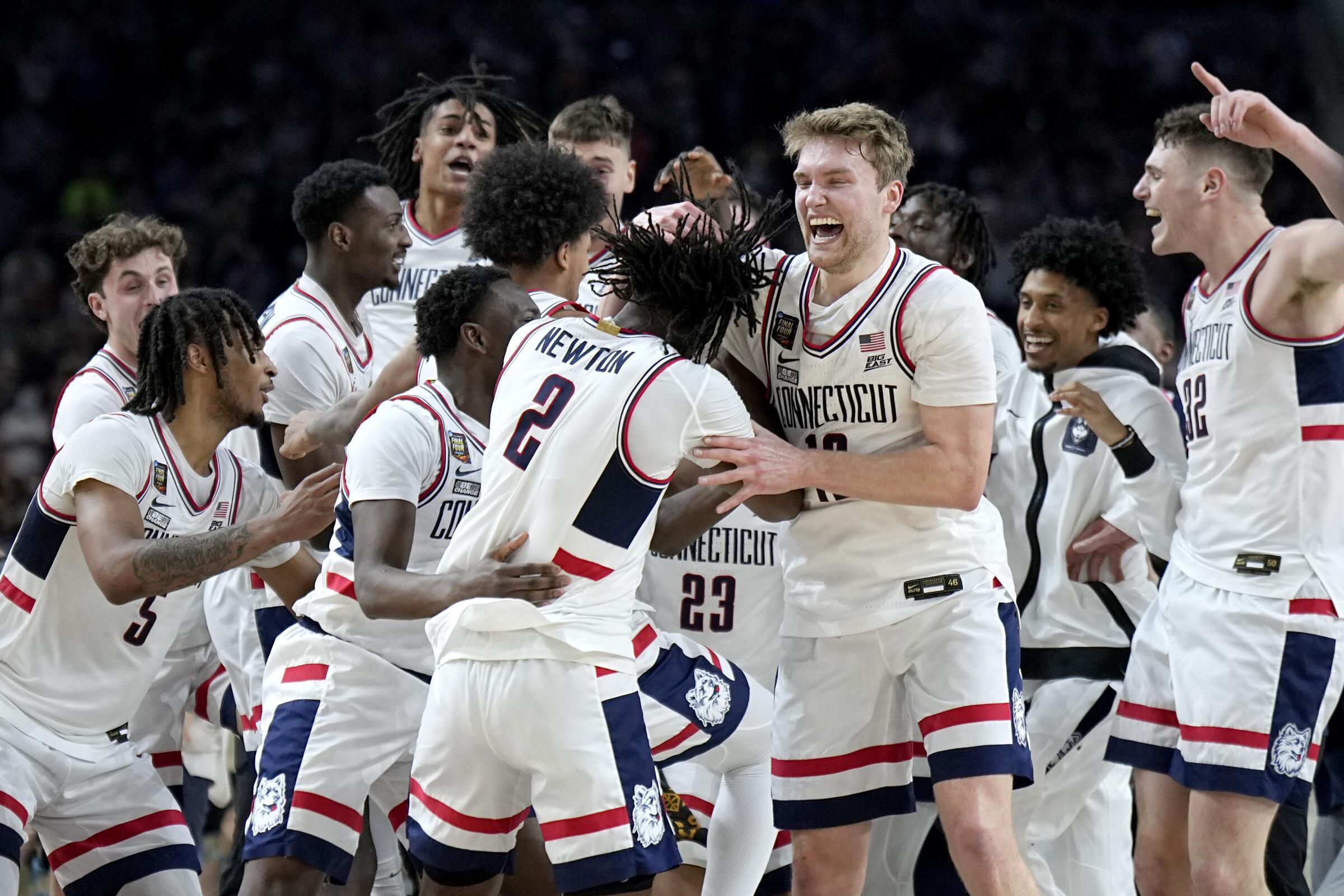 UConn players celebrate as time expires during the second half of the NCAA college Final Four.