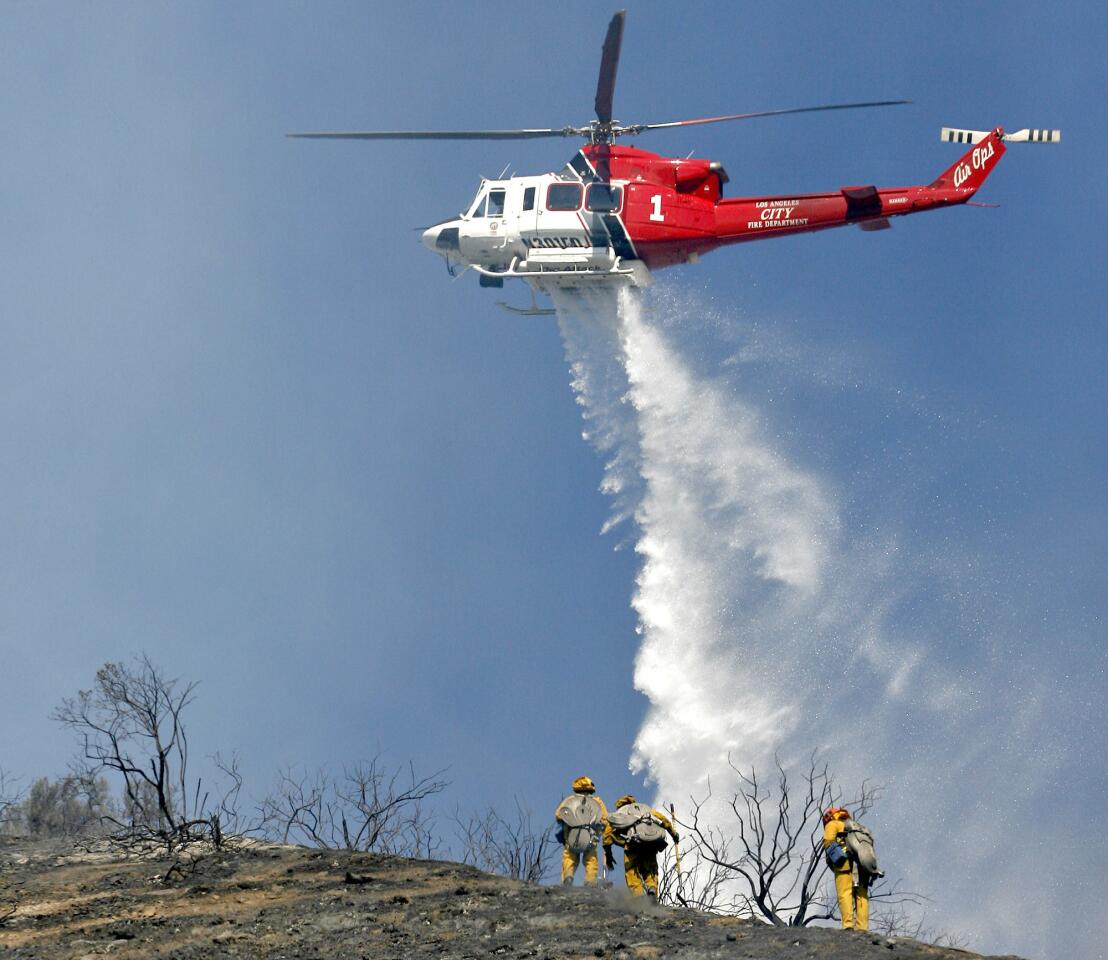 A City of L.A. Fire Dept. helicopter drops water on a fire on the hills north the 134 Frwy. east of the 2 Frwy. oin Eagle Rock on Tuesday, Oct. 30, 2012. The fire was knocked down in about 2 hours.