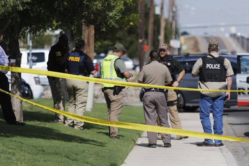Authorities cordon off a part of the sidewalk in the 5100 block of E. 42nd Street in Odessa, Texas, Saturday, Aug. 31, 2019. Several people were dead after a gunman who hijacked a postal service vehicle in West Texas shot more than 20 people, authorities said Saturday. The gunman was killed and a few law enforcement officers were among the injured. (Mark Rogers/Odessa American via AP)