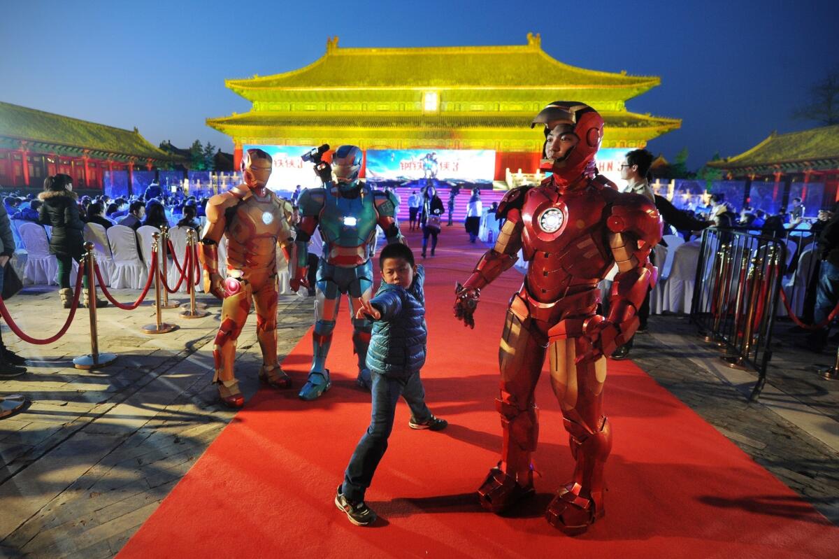 This picture taken on April 6, 2013 shows a boy posing during a promotional event for the Hollywood movie "Iron Man 3" at the Forbidden City in Beijing.