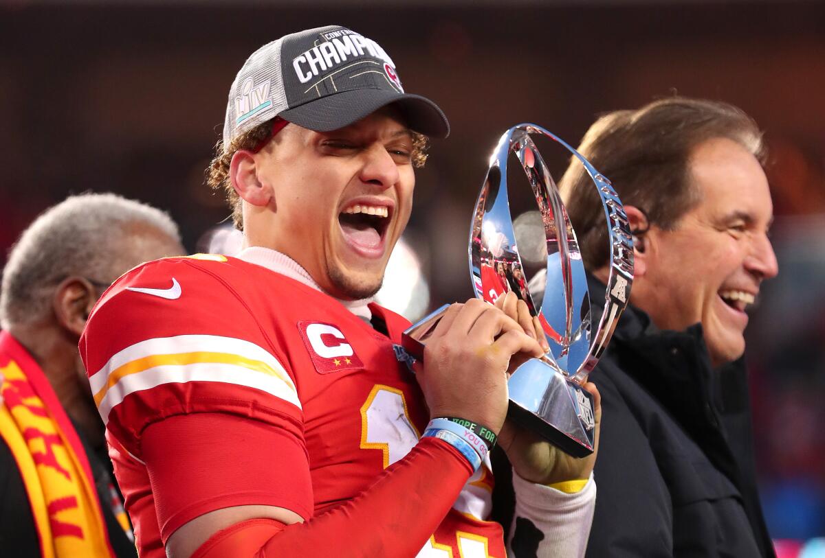 Kansas City quarterback Patrick Mahomes holds up the Lamar Hunt Trophy after the Chiefs beat the Tennessee Titans in the AFC championship game Sunday at Arrowhead Stadium.