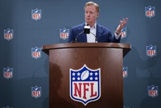 NFL commissioner Roger Goodell stands behind a podium and responds to questions during a news conference 