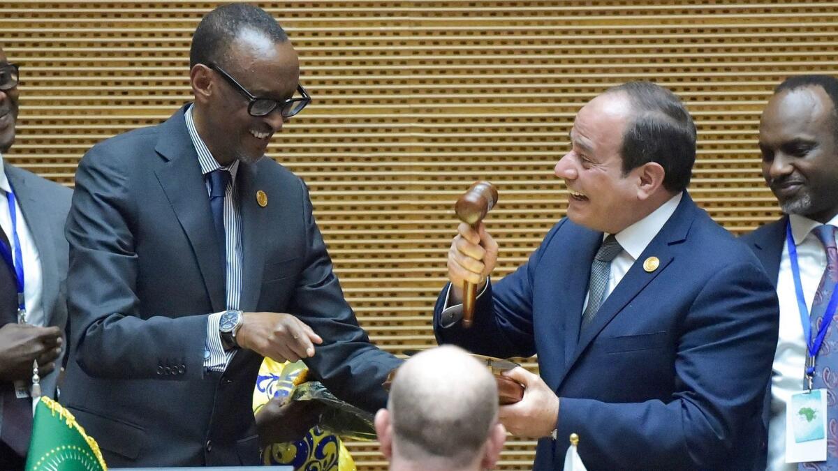 Egyptian President Abdel Fattah Sisi, right, speaks with outgoing African Union Chairman and Rwandan President Paul Kagame, after Sisi was elected the new chairman during the 32nd African Union summit in Addis Ababa, Ethiopia, on Feb. 10, 2019.