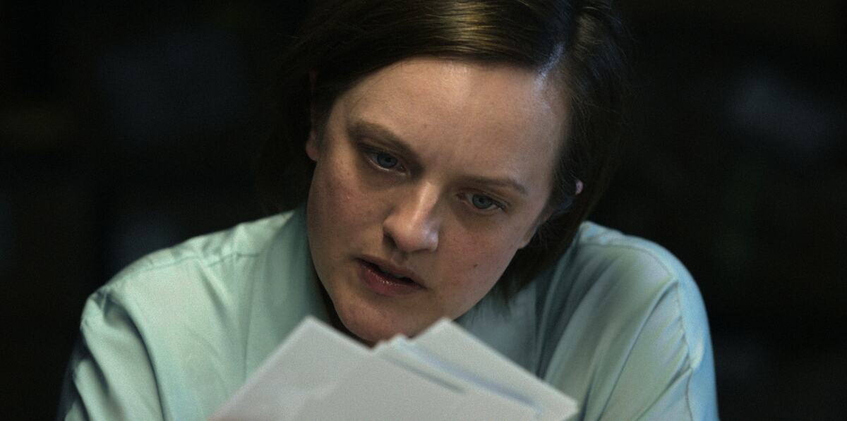 A woman pores over documents.