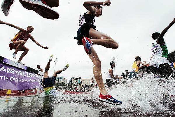 Ioran Etchechury of Brazil trips and falls into the water during the boys' 2000-meter steeplechase at the Youth Olympics in Singapore on Wednesday.