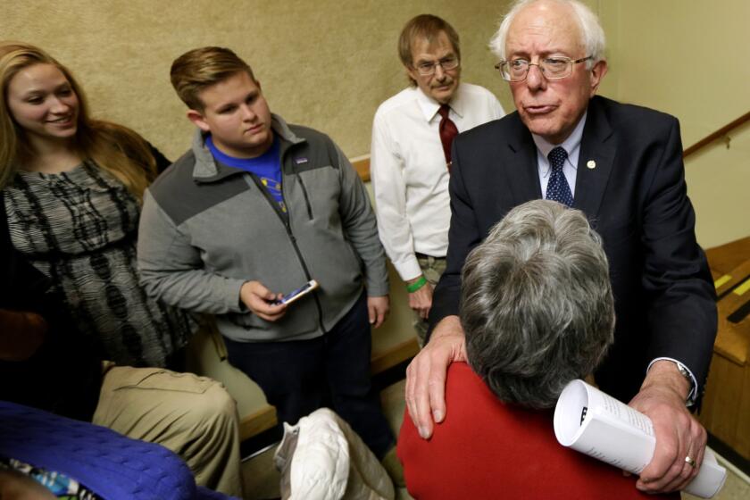 Sen. Bernie Sanders (I-Vt.), right, talks with local residents after a town hall meeting in Ames, Iowa, on Dec. 16, 2014. The self-styled socialist would probably run in the Democratic caucuses as a liberal voice in a field that could include Hillary Rodham Clinton.