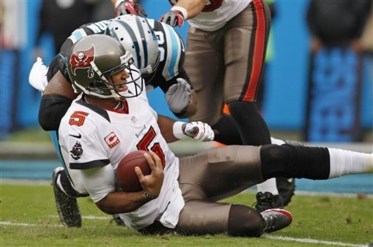Tampa Bay Buccaneers' Josh Freeman (5) is hit as he slides by Carolina Panthers' James Anderson (50) during the first half of an NFL football game in Charlotte, N.C., Sunday, Nov. 18, 2012. Anderson was called for a personal foul. (AP Photo/Nell Redmond)