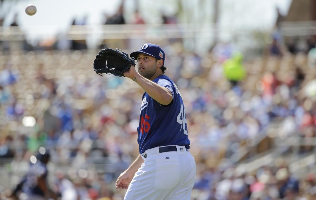 Dodgers right-hander Mike Bolsinger catches a ball during the second inning of a spring training game on March 14.