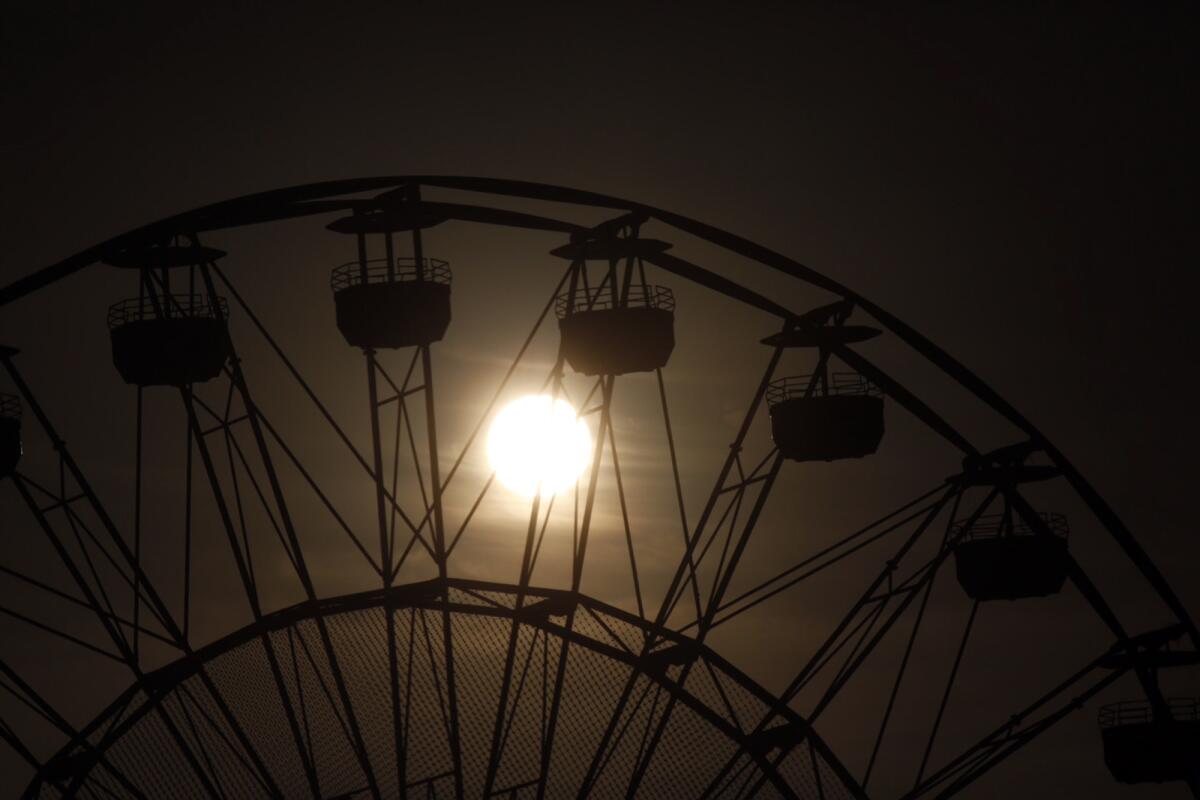 Sunrise over the Ferris wheel at the Irvine Spectrum. Southland temperatures are expected to climb through the weekend with highs topping 100 degrees in parts of the San Fernando Valley.