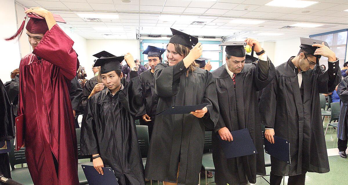 Graduates flip their tassels during the Glendale Community College GED program graduation ceremony on Tuesday, December 17, 2013.