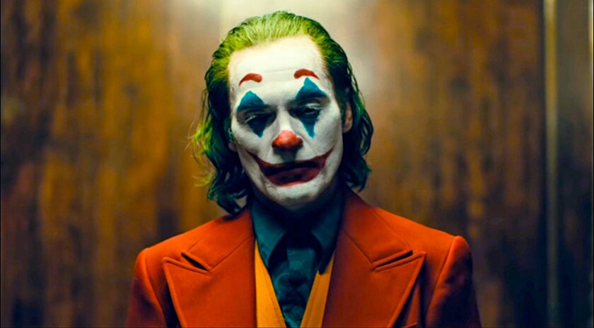 Joaquin Phoenix with green hair and clown makeup in "Joker."