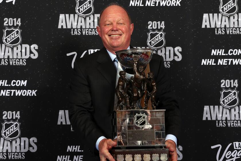 Ducks Executive Vice President and General Manager Bob Murray holds a trophy after being named the NHL's general manager of the year in 2014.