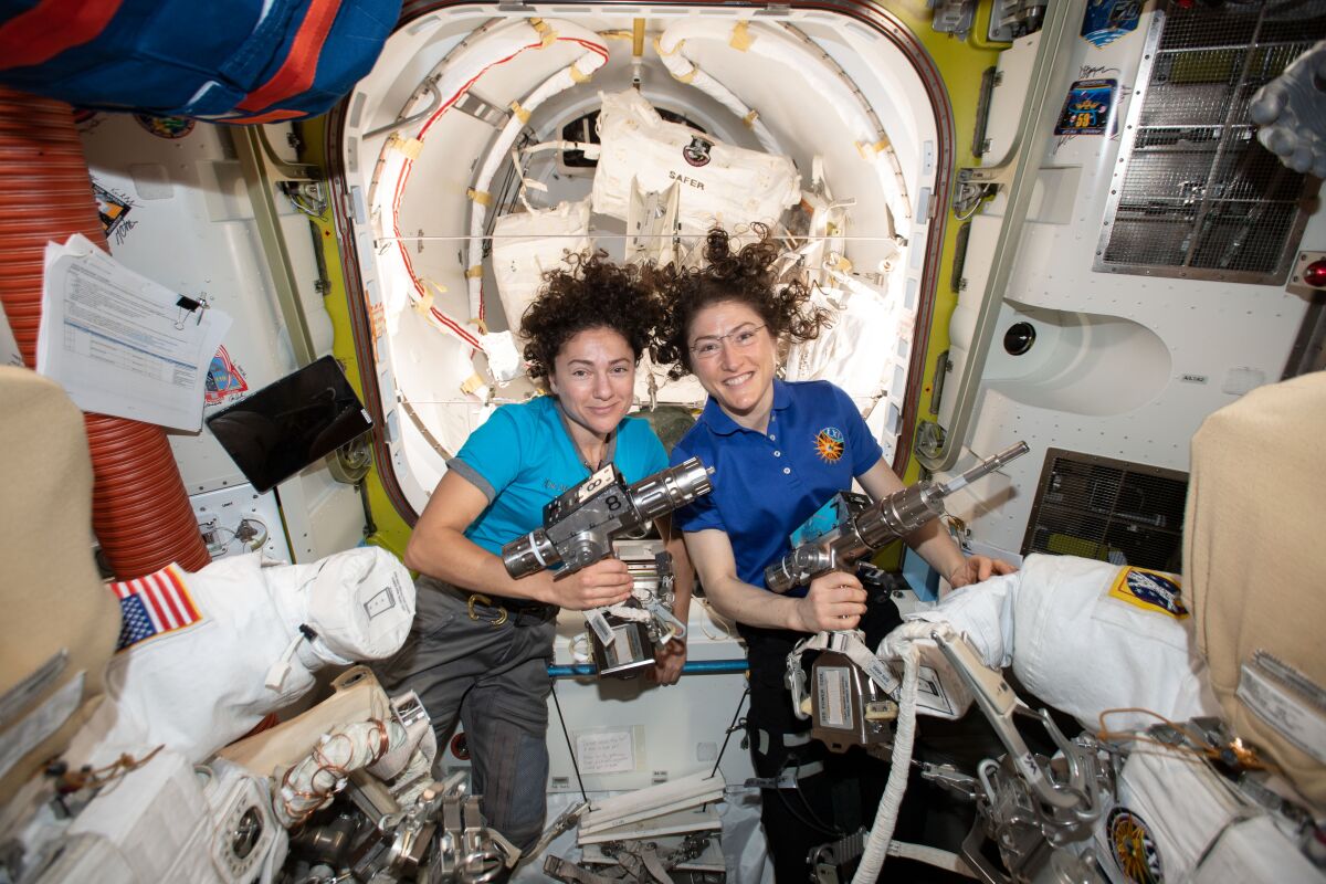 NASA astronauts Jessica Meir, left, and Christina Koch inside the Quest airlock preparing for their first spacewalk together. 