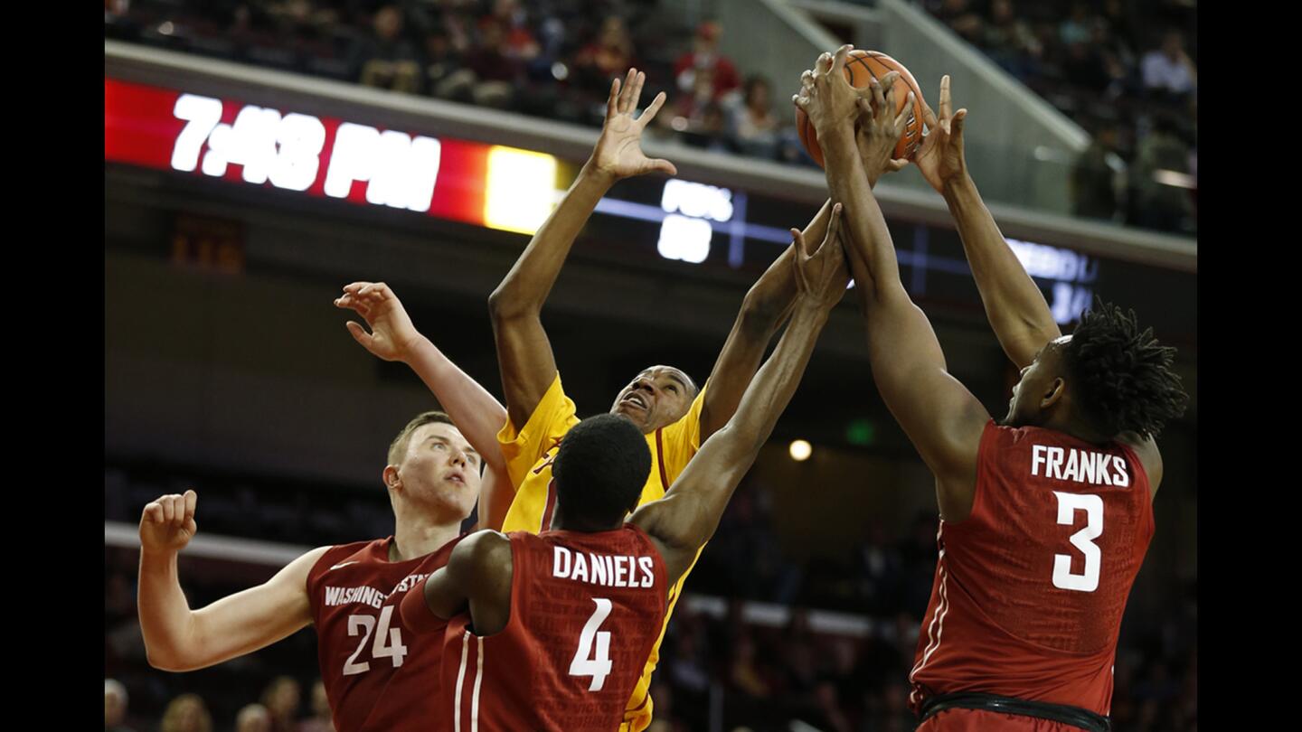 USC guard Aaron Shaqquan, center, battles a trio of Washington State players for a rebound during the first half.