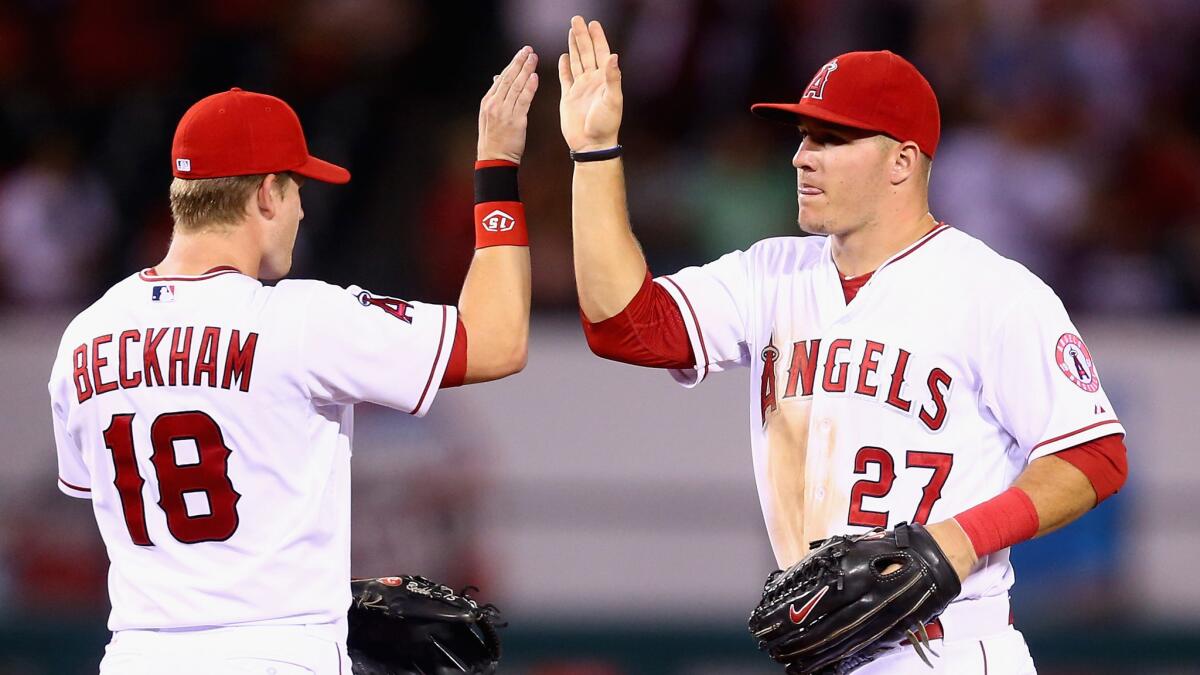 Angels second baseman Gordon Beckham celebrates with center fielder Mike Trout following the team's 6-1 win over the Miami Marlins on Wednesday.