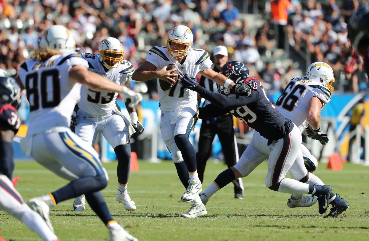 Chargers quarterback Philip Rivers ends up fumbling the ball while trying to evade a sack.