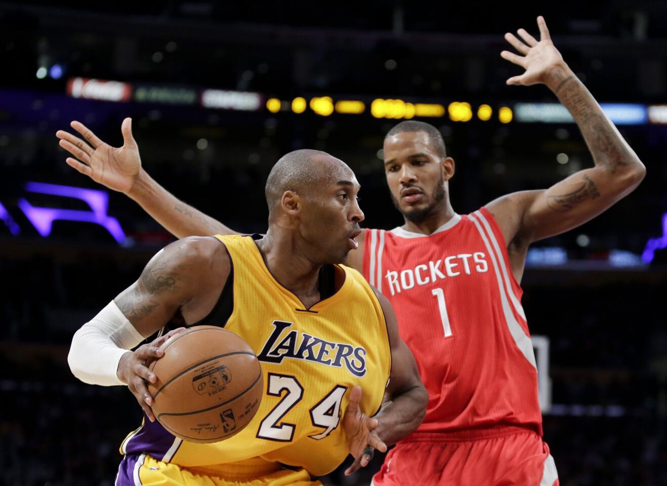 Los Angeles Lakers forward Kobe Bryant, left, drives around Houston Rockets forward Trevor Ariza during the second half on Thursday.