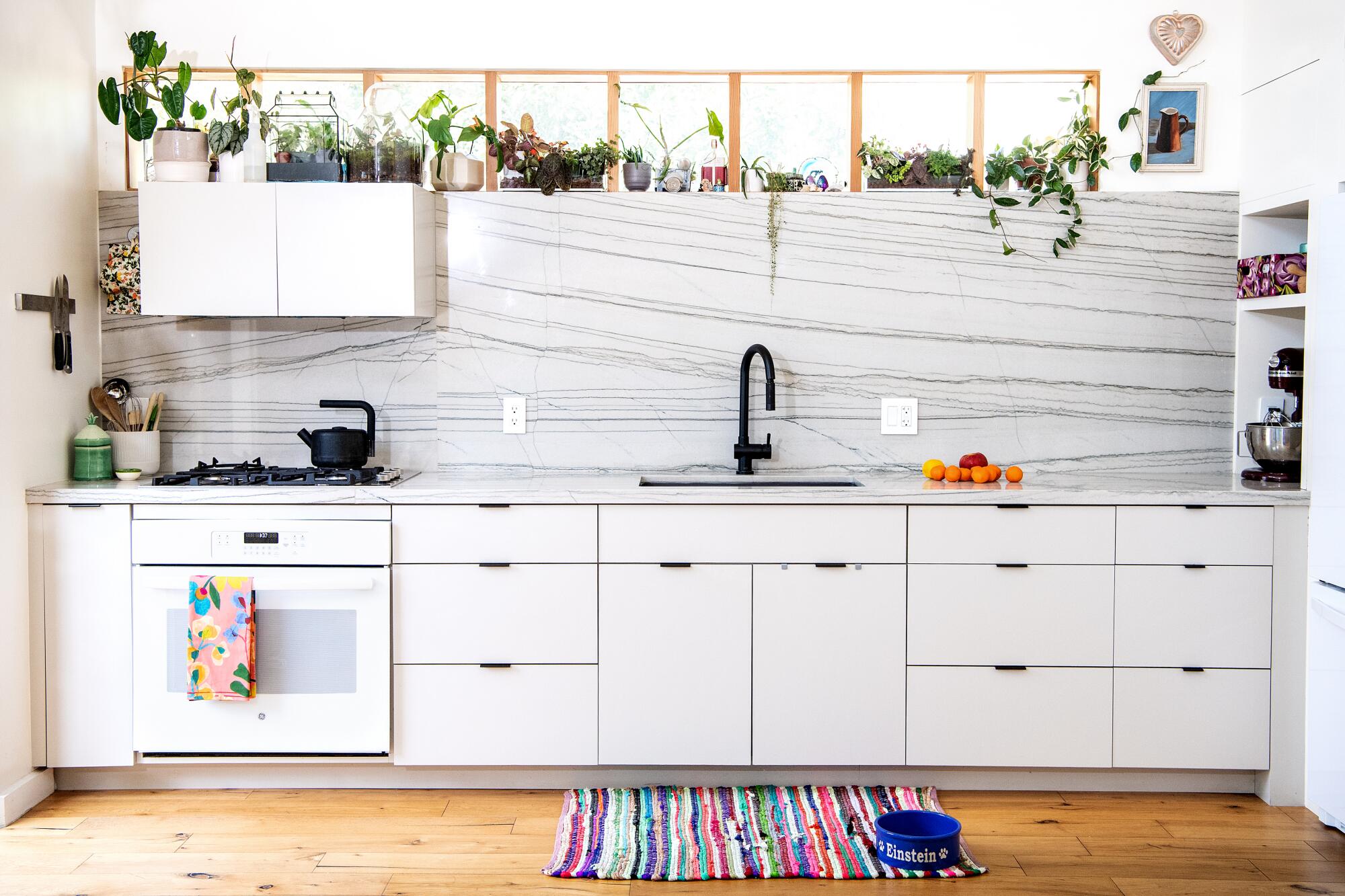 A bright open kitchen with white cabinets