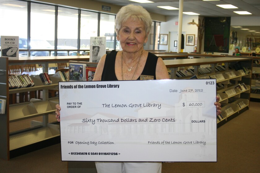 Rosemary Putnam holds a check for the Lemon Grove library in 2012. The longtime advocate of literacy passed away on June 25.