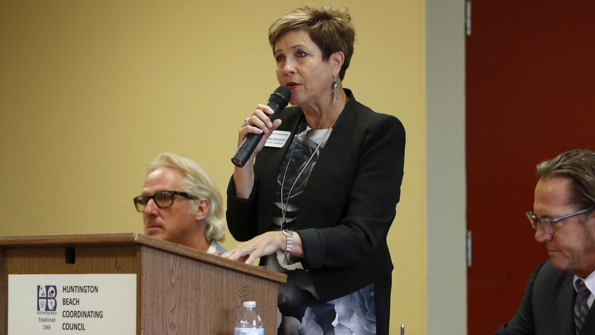 Incumbent Barbara Delgleize addresses the audience during a Huntington Beach City Council candidates forum on Monday.