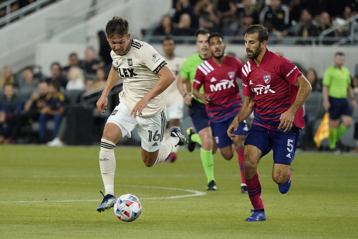 LAFC forward Danny Musovski, left, dribbles past Dallas FC's Quignon