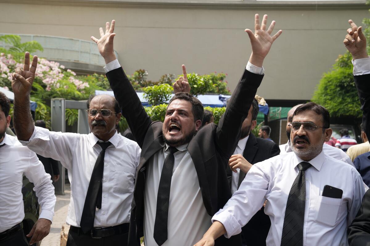 Lawyers and supporters of Pakistan's former Prime Minister Imran Khan chant slogans against the court decision
