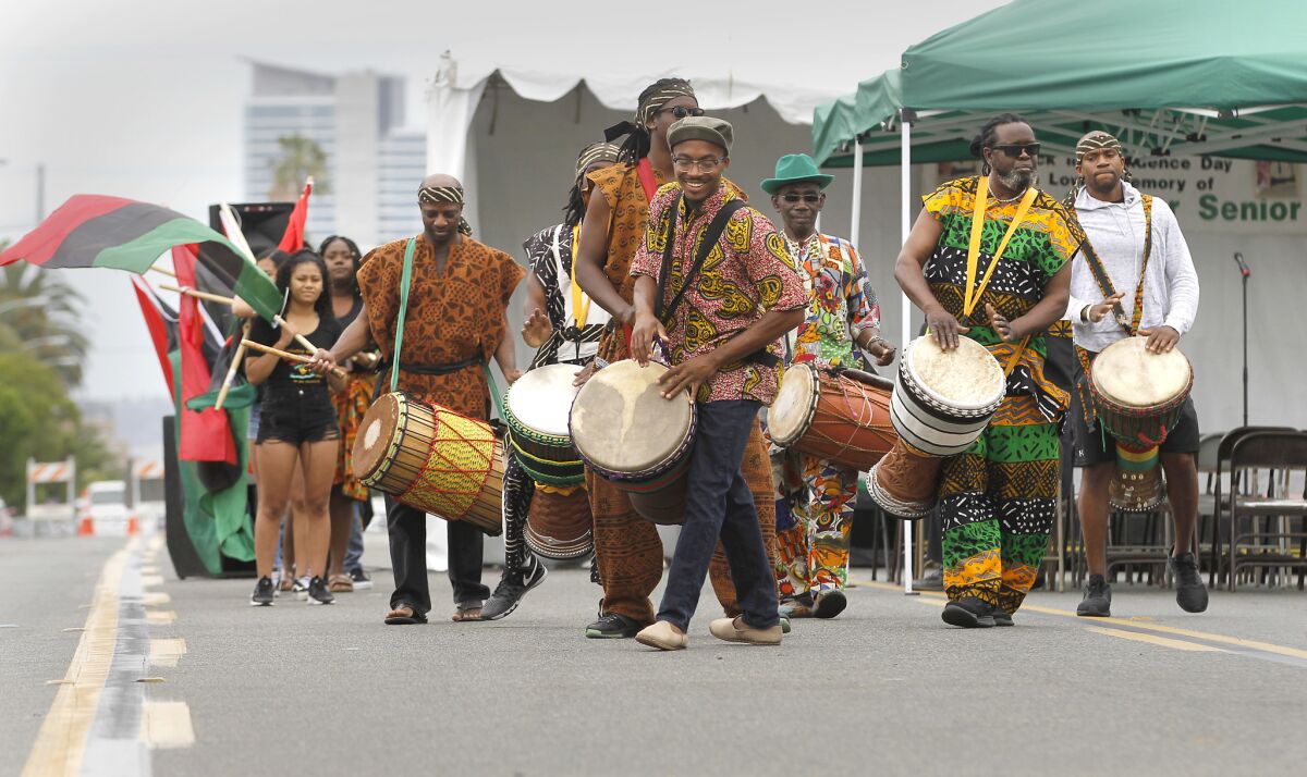 Members of an African drum and dance company lead a Juneteenth parade in 2018.