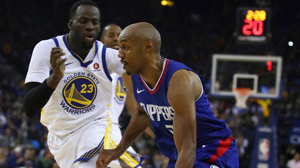 Clippers' C.J. Williams, right, drives against Golden State Warriors' Draymond Green during the first half on Wednesday.