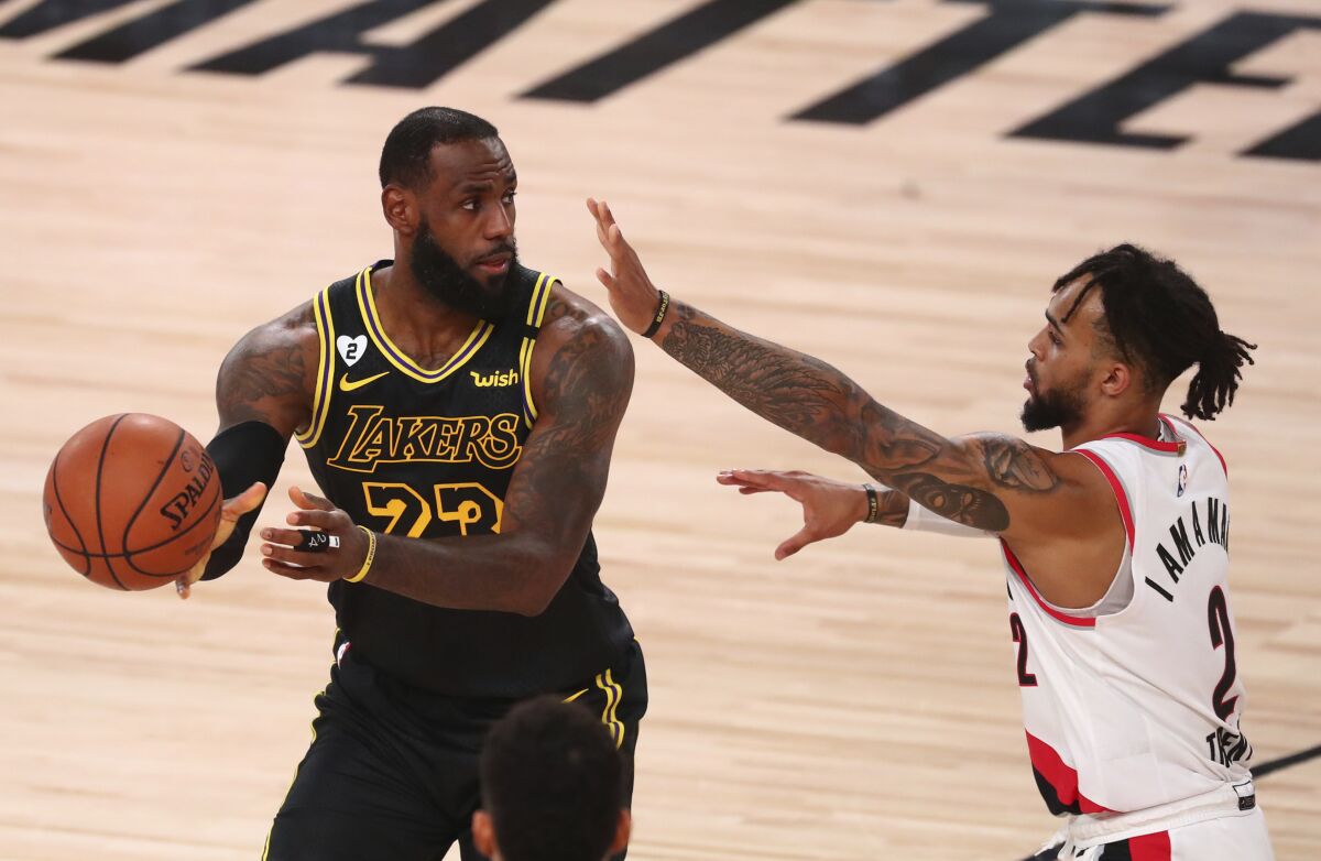 LeBron James controls the ball in front of Portland guard Gary Trent Jr. during Game 4.