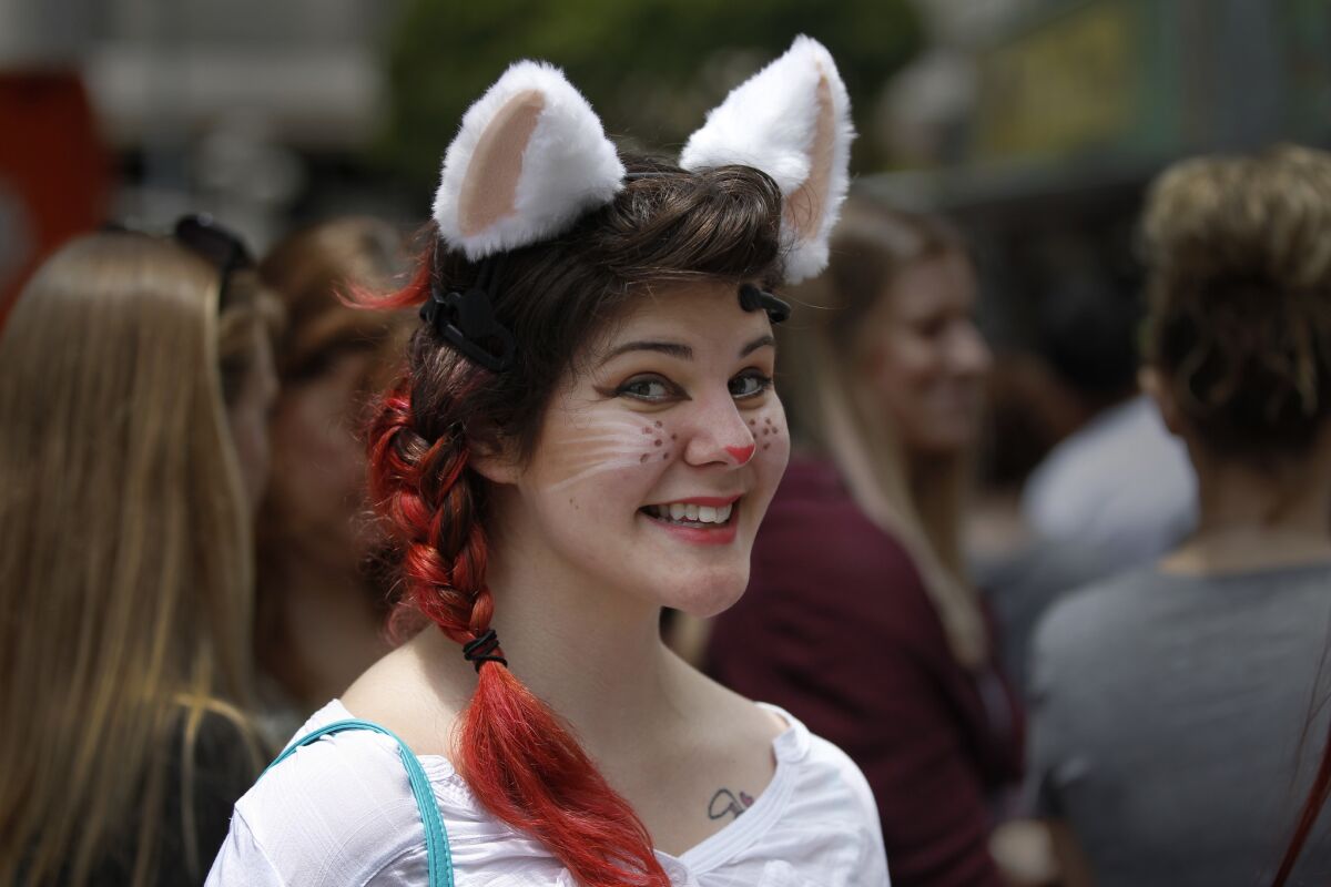 Mika Mennecke of Santa Barbara sports moving cat ears and makeup Saturday as part of her costume to show her love for felines during CatConLA.