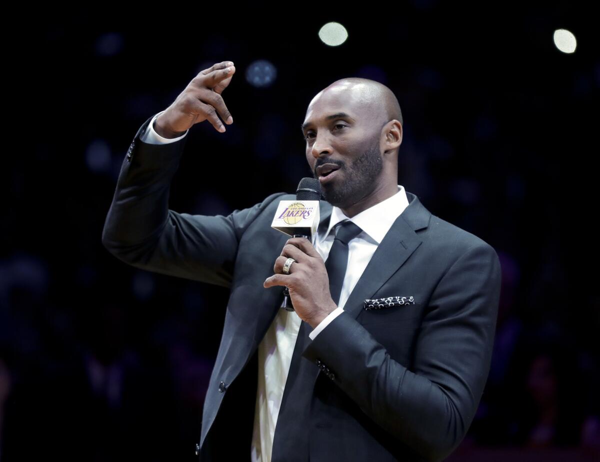 Former Los Angeles Laker Kobe Bryant speaks during a halftime ceremony retiring both of his jersey's during an NBA basketball game between the Los Angeles Lakers and the Golden State Warriors, in Los Angeles, Monday, Dec. 18, 2017.