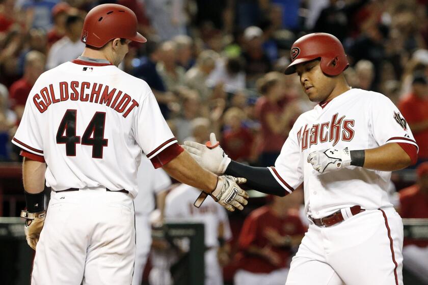 Diamondbacks outfielder Yasmany Tomas is congratulated by Paul Goldschmidt after hitting a two-run home run against the Dodgers.
