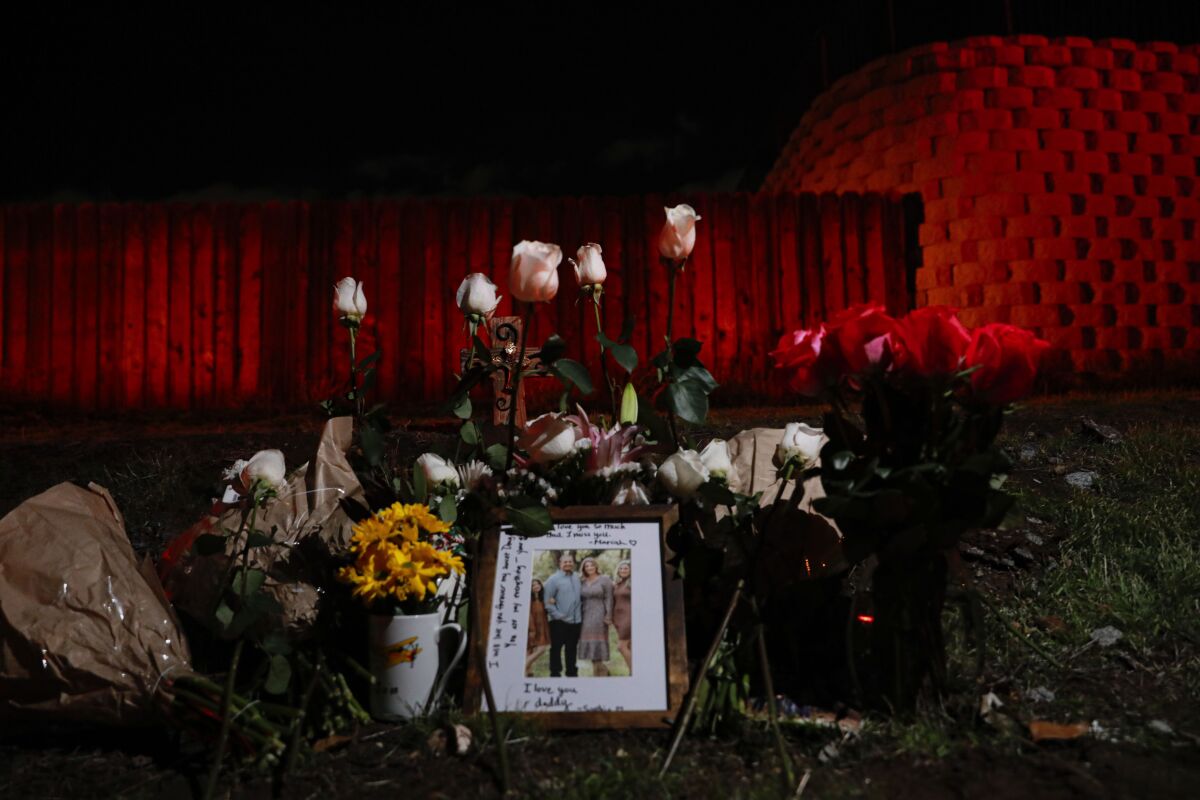 Victims' loved ones left flowers, a photo and other items at the site on Pepper Drive near Lakeside on December 29, 2021.