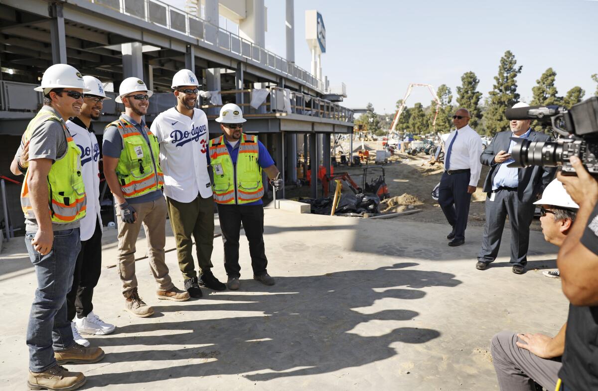 The newest Dodgers Mookie Betts and David Price pose for a photo with construction workers at Dodger Stadium.