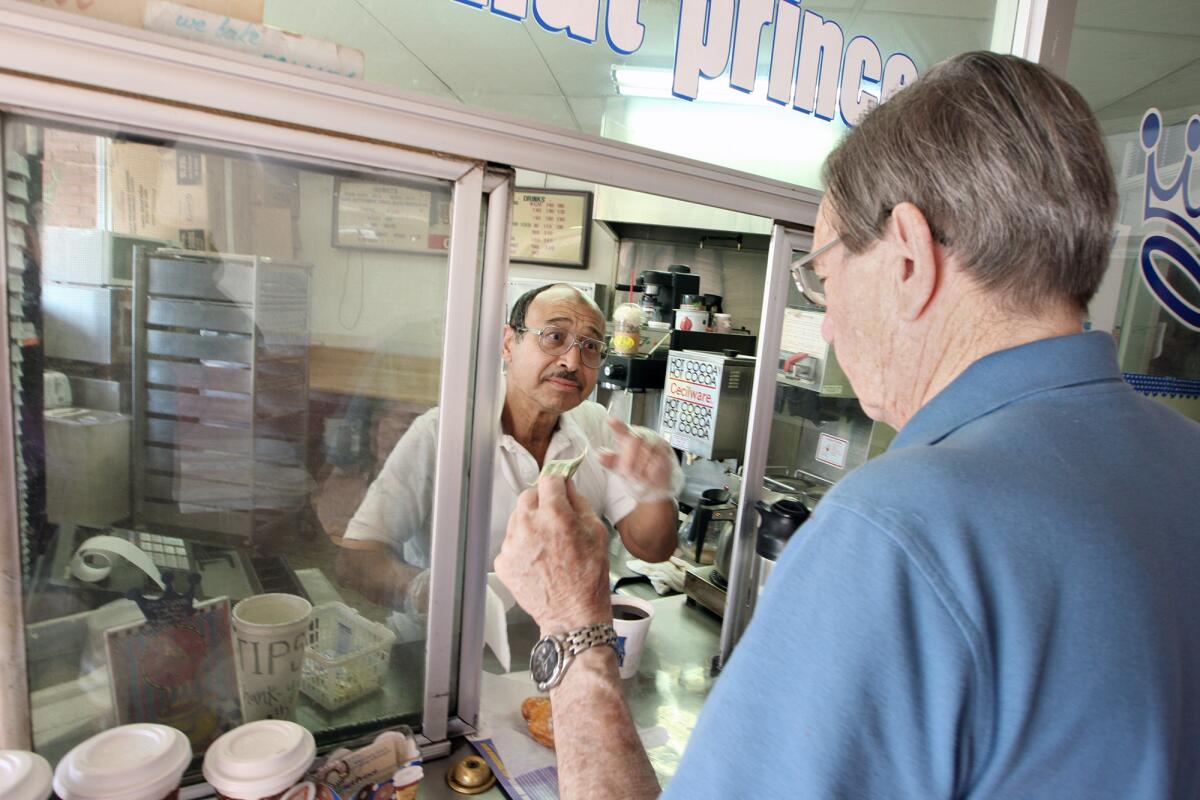 Donut Prince owner Mike Abdelghani helps longtime customer Glenn Brown with coffee and, of course, a donut on Monday, August 26, 2013.