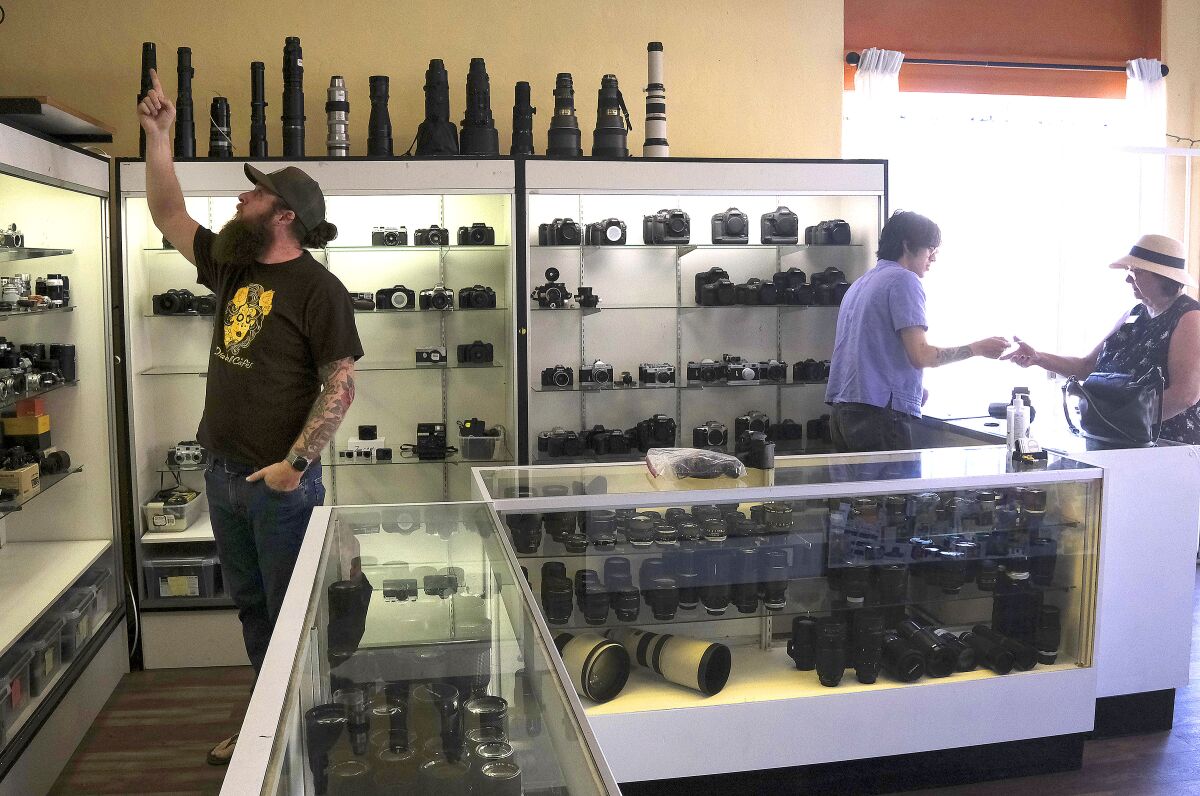 Camera Exposure & Safelight Labs co-owner Rob Cowan, left, stands in the North Park store
