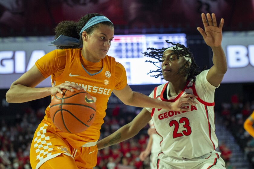 Tennessee Lady Vols guard Rae Burrell (12) drives past Georgia Lady Bulldogs guard Que Morrison (23) during the first half of an NCAA college basketball game Sunday, Jan. 23, 2022, in Athens, Ga. (AP Photo/Hakim Wright Sr.)