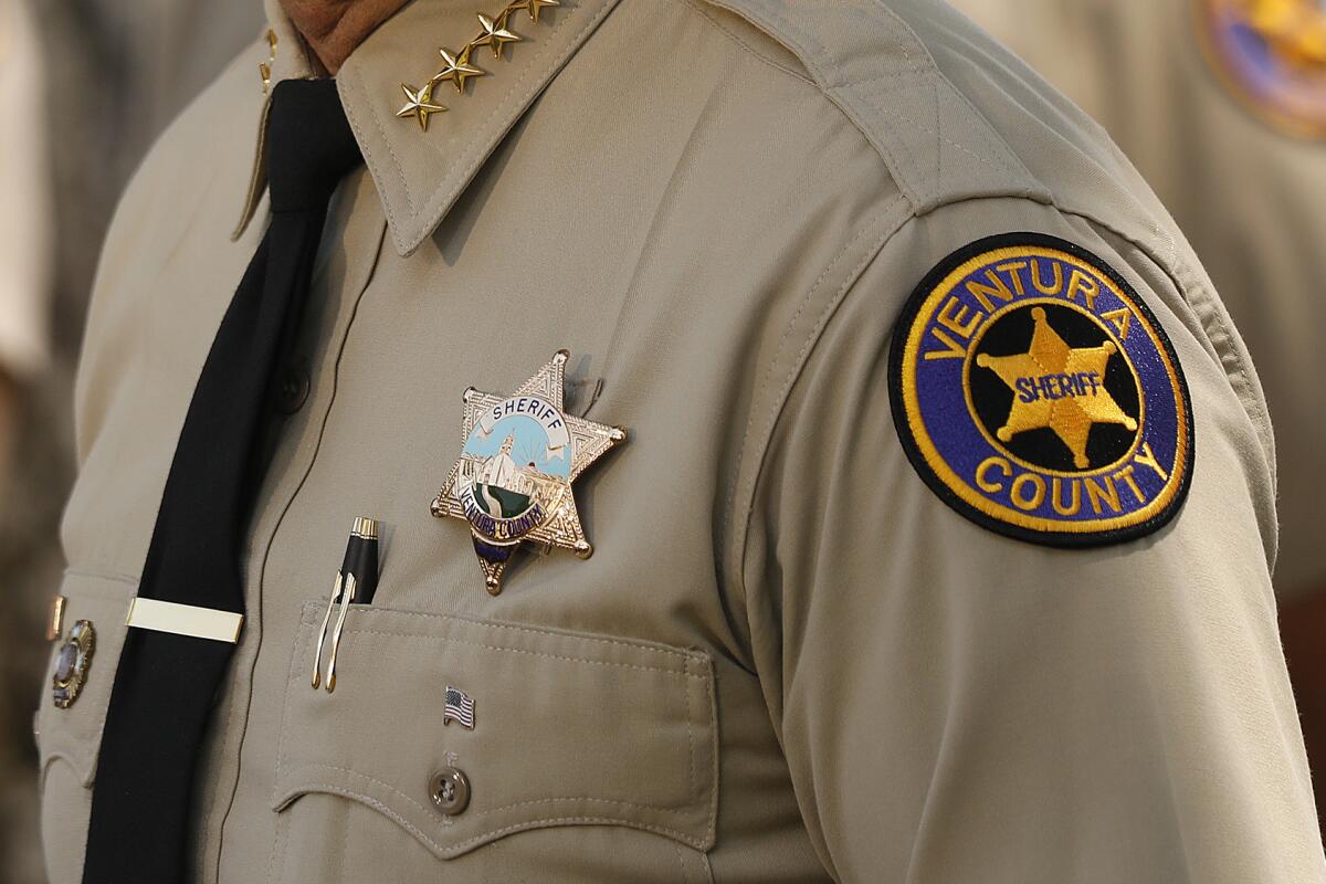Closeup of the shoulder of a uniformed man with a patch that reads "Ventura County Sheriff."