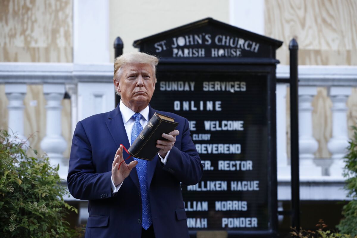 President Trump holds a Bible as he stands outside St. John's Church near the White House.