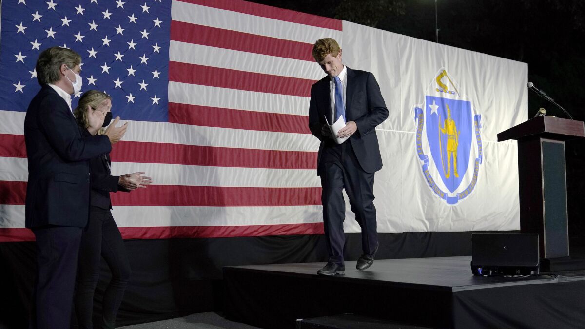 U.S. Rep. Joe Kennedy III leaves the stage after speaking outside his campaign headquarters in Watertown, Mass., after conceding defeat to incumbent U.S. Sen. Edward Markey, Tuesday, Sept. 1, 2020, in the Massachusetts Democratic Senate primary. Applauding at left are his twin brother Matthew and wife Lauren. (AP Photo/Charles Krupa)